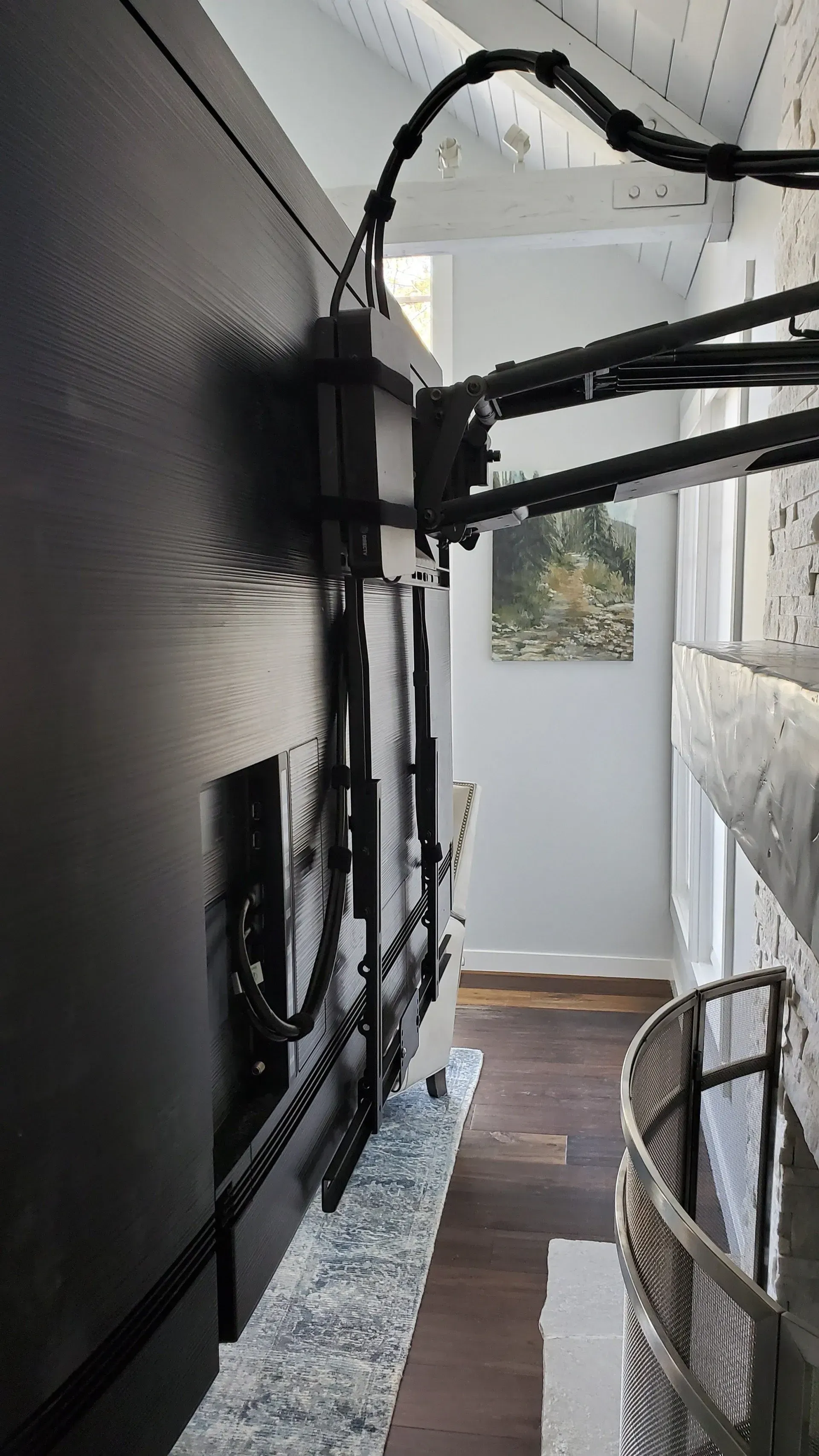 A flat screen tv is mounted to the wall in a living room.