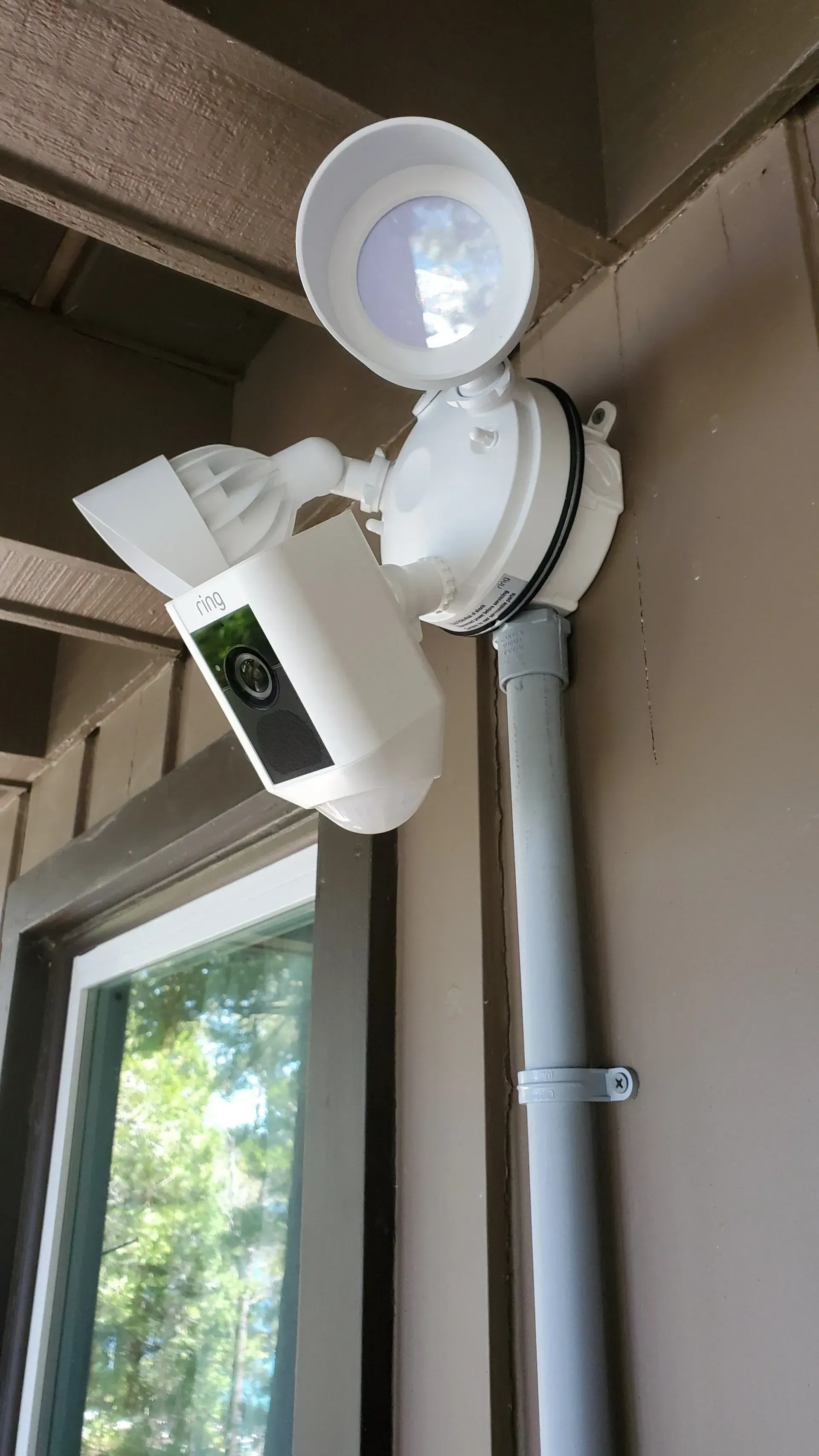 A security camera is mounted on the side of a building.