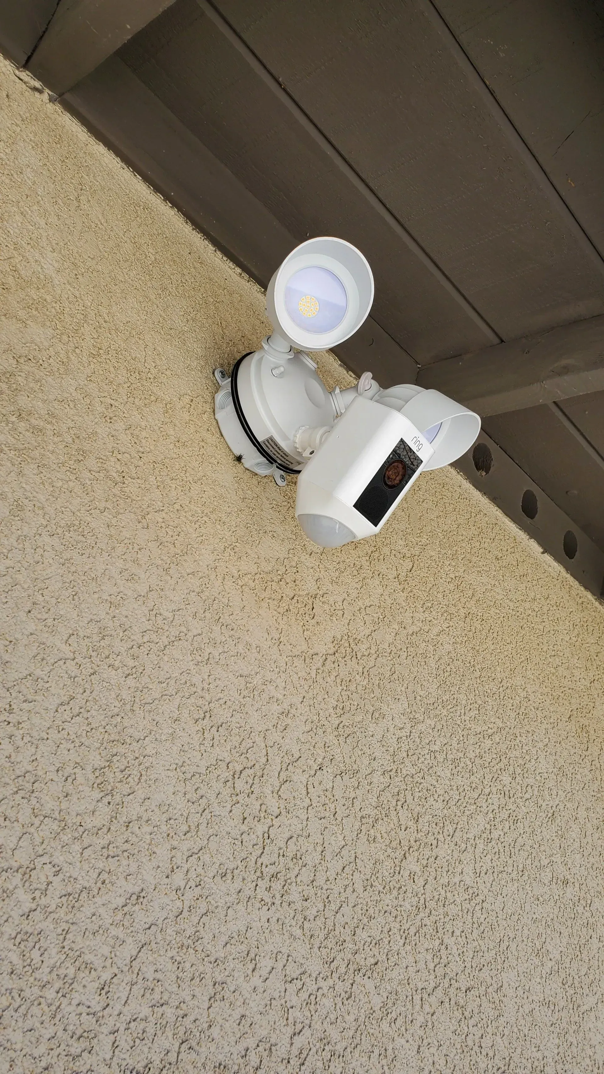 A security camera is mounted on the side of a building.