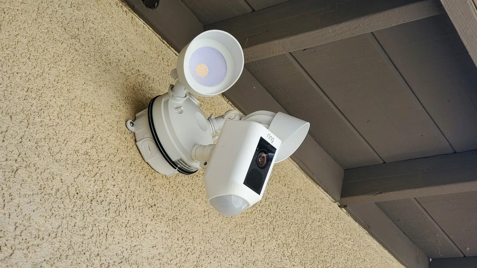 A security camera is mounted on the side of a building.