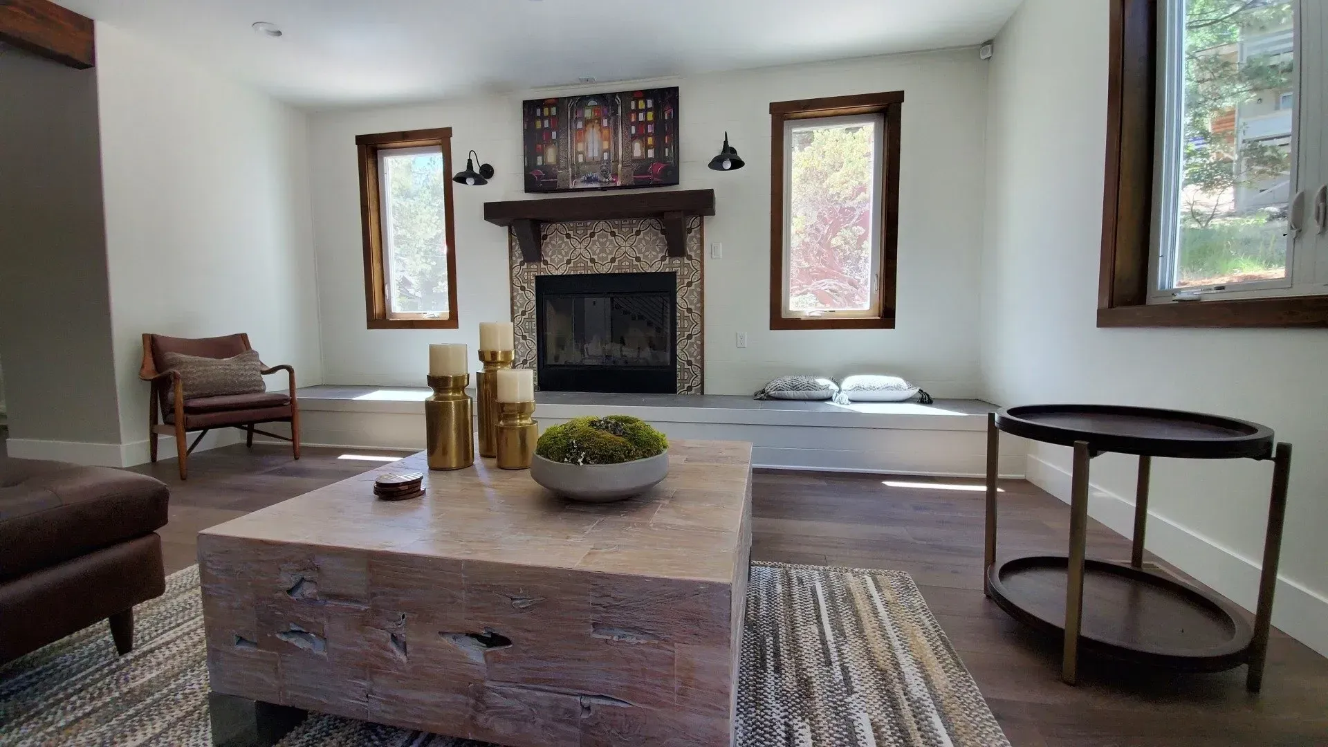 A living room with a fireplace and a coffee table.
