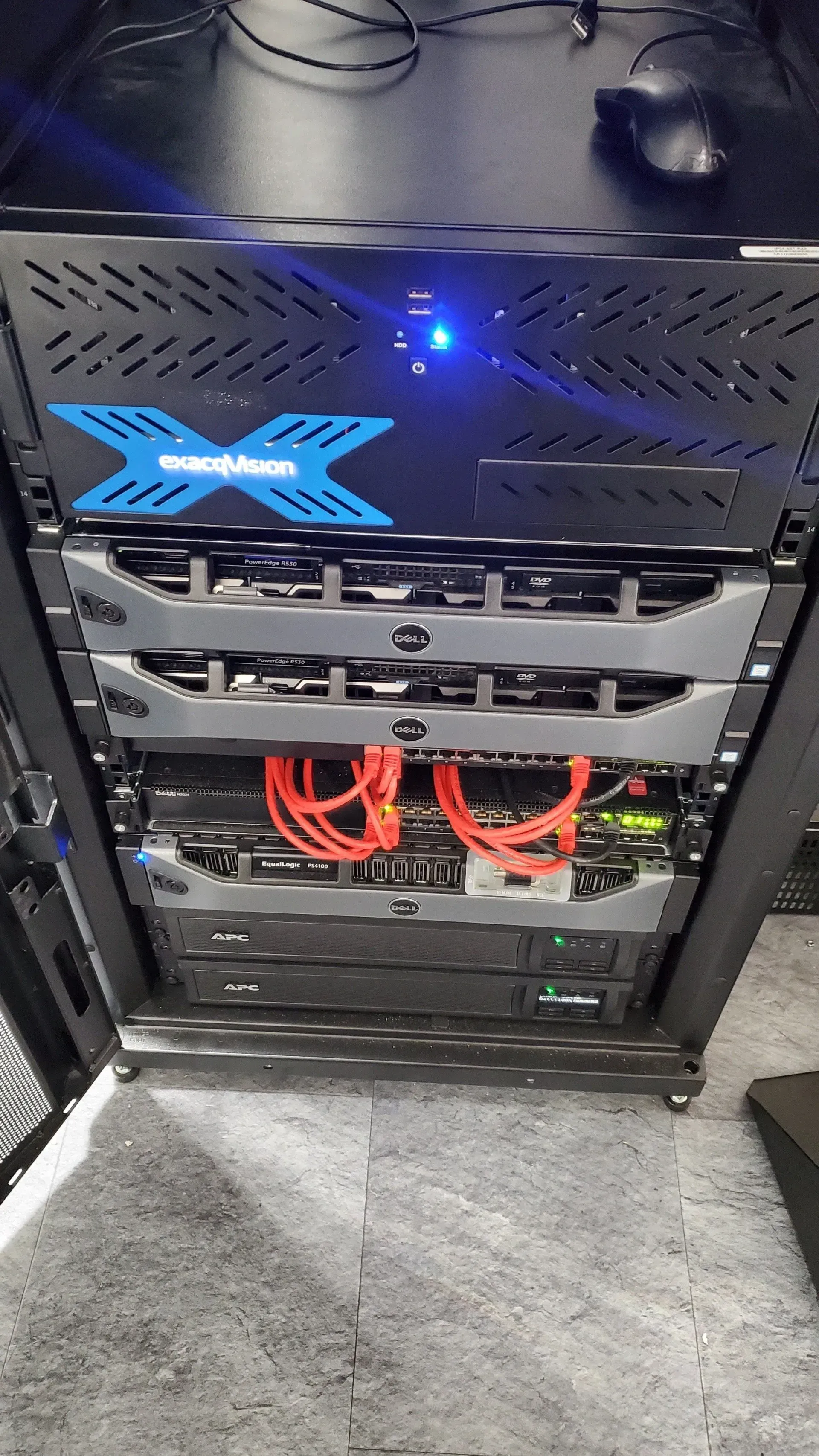 A server rack with a lot of servers and cables on it.