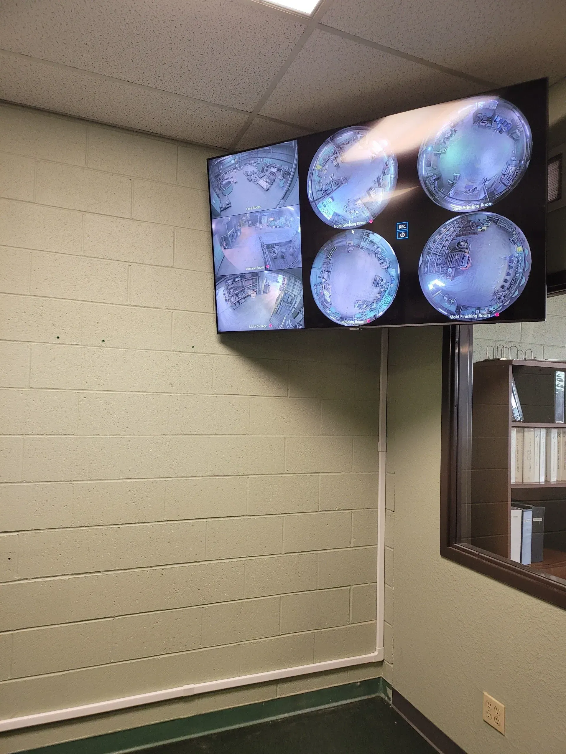 A room with a tv on the wall and a window