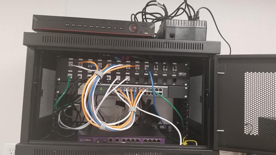 A server rack with a lot of wires coming out of it.