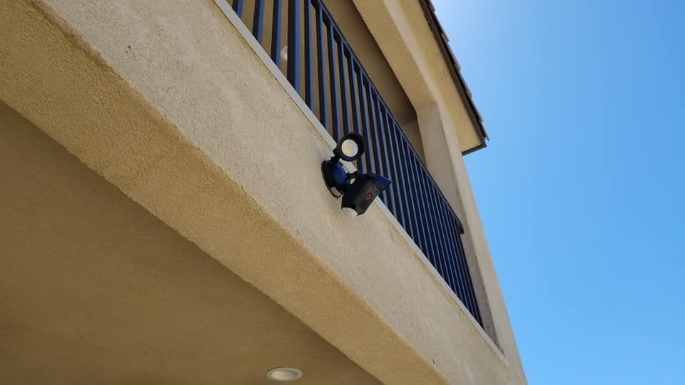 A building with a balcony and a light on the side of it.