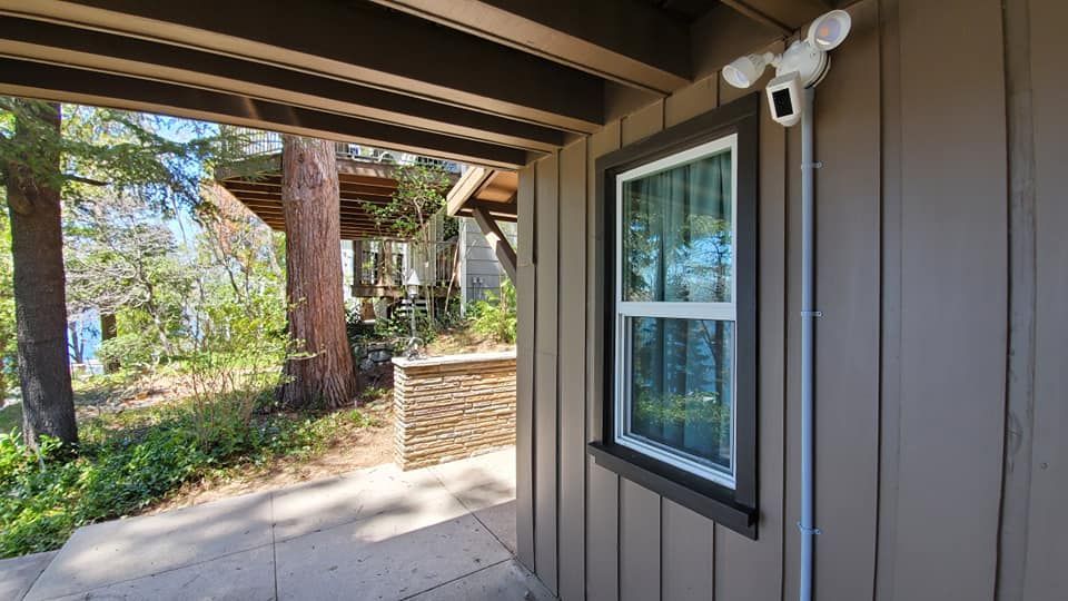 A house with a window and a camera on the side of it.