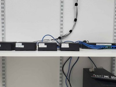 A shelf with a bunch of wires connected to it