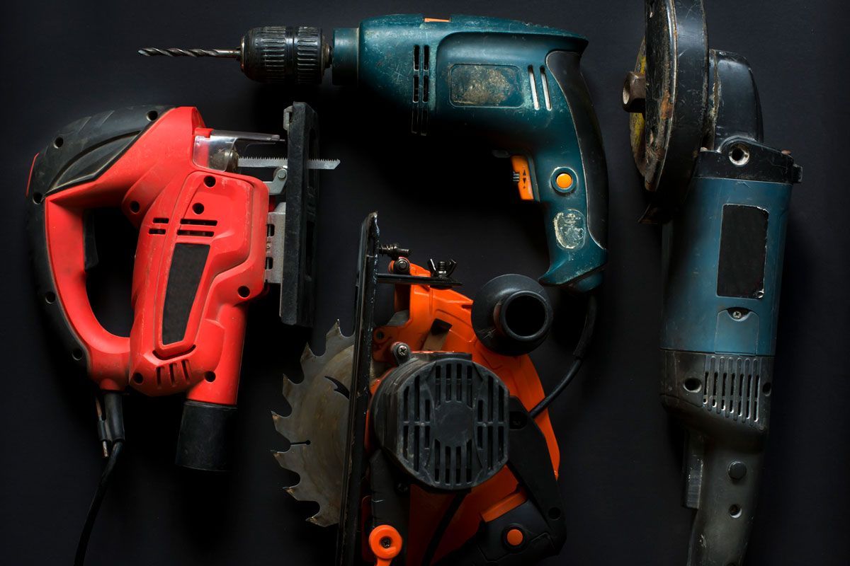 A group of tools are sitting on top of each other on a black background.