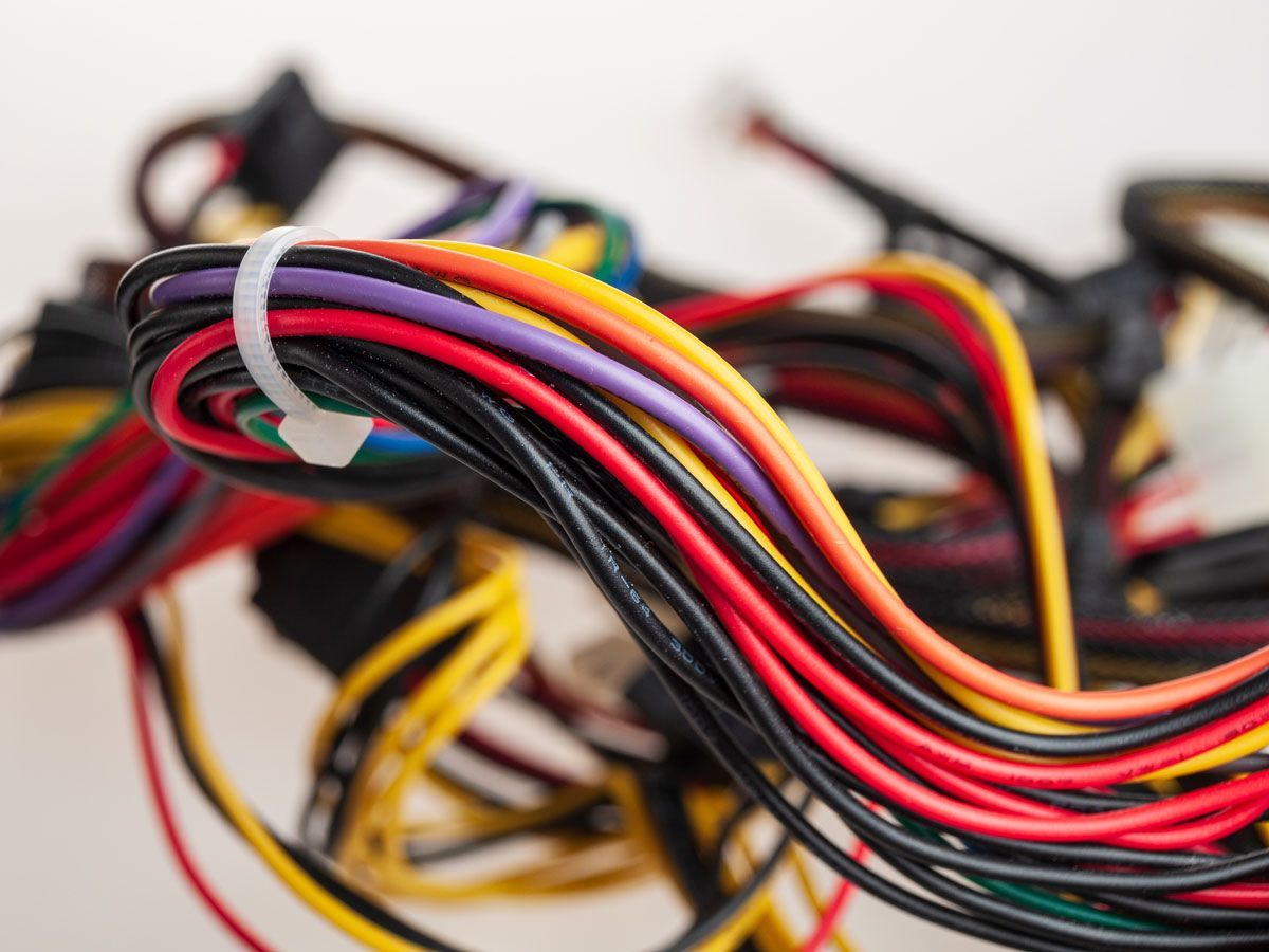 A bunch of wires are tied together with a white tape