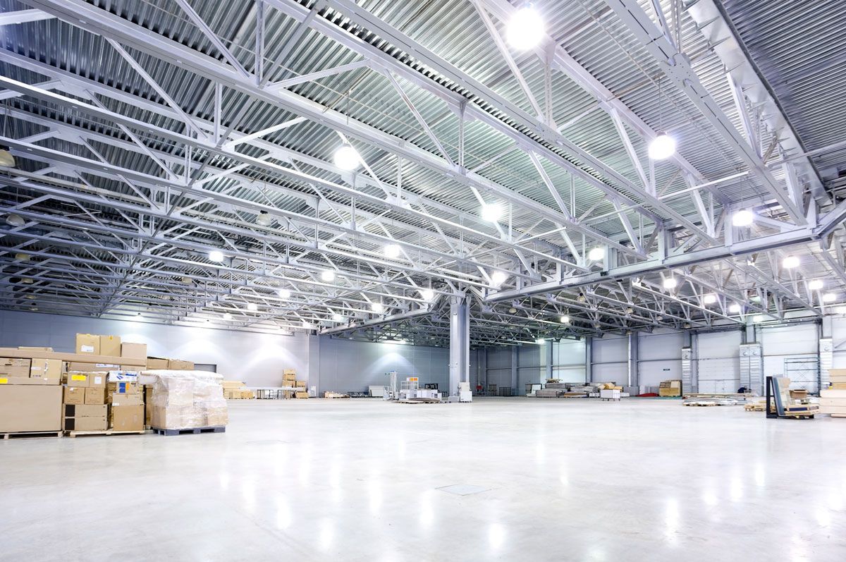 A large warehouse filled with lots of boxes and lights.