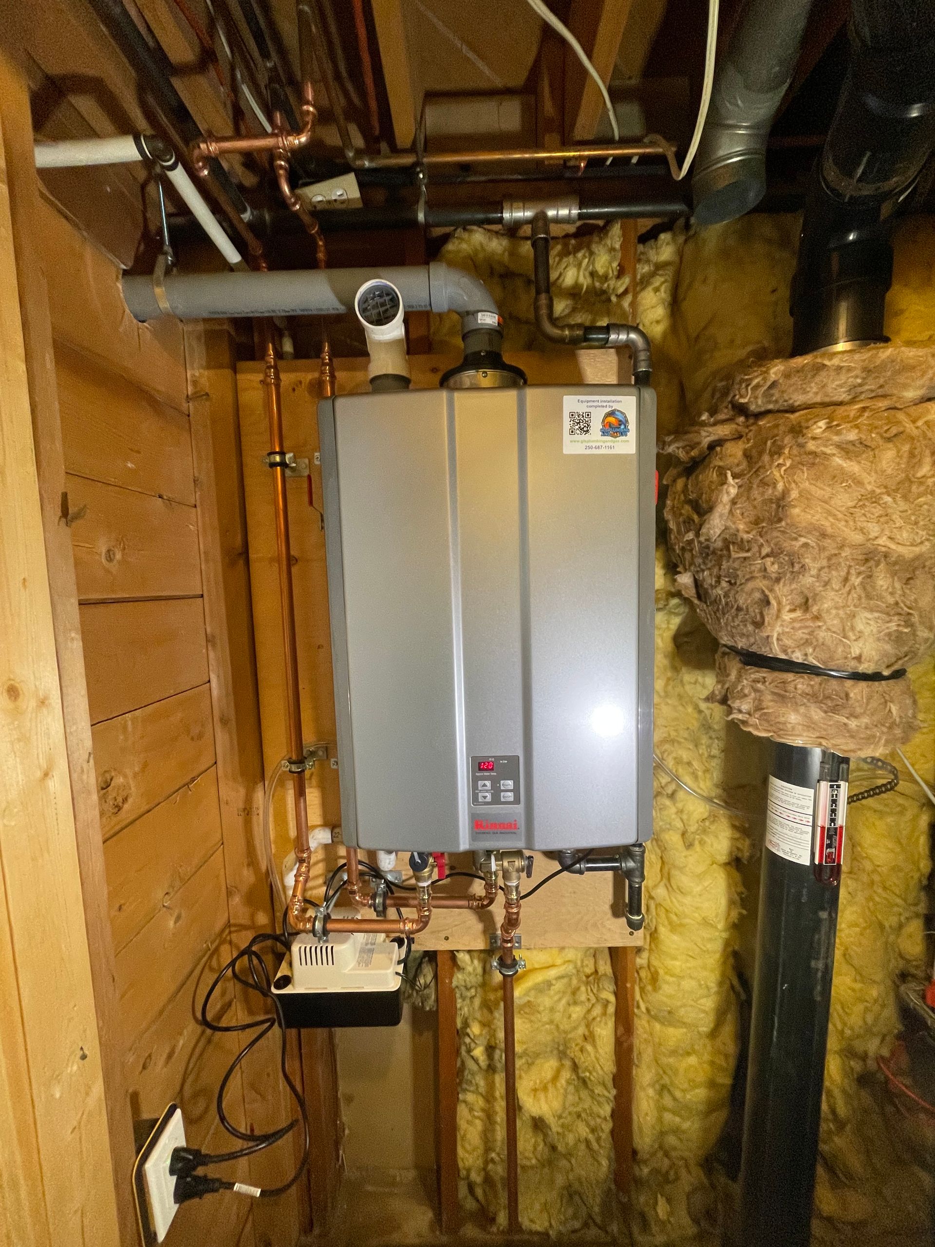 A water heater is hanging from the ceiling in a room.
