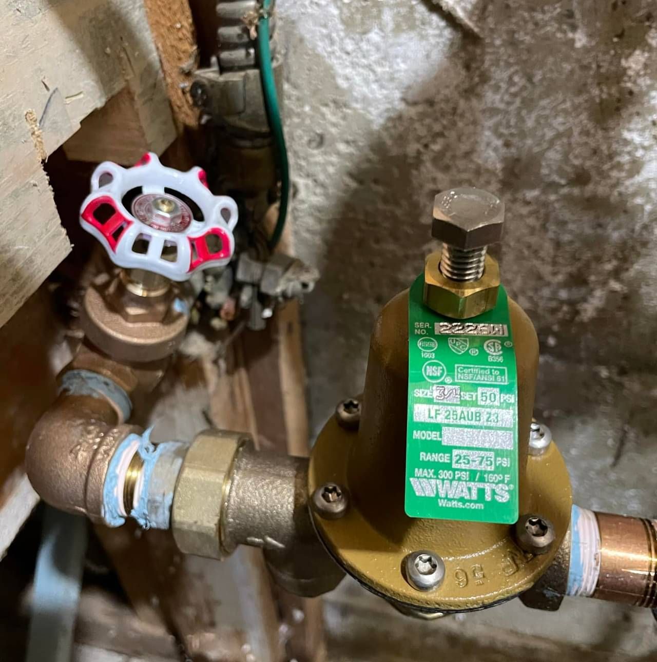 A valve with a green label that says what 's on it