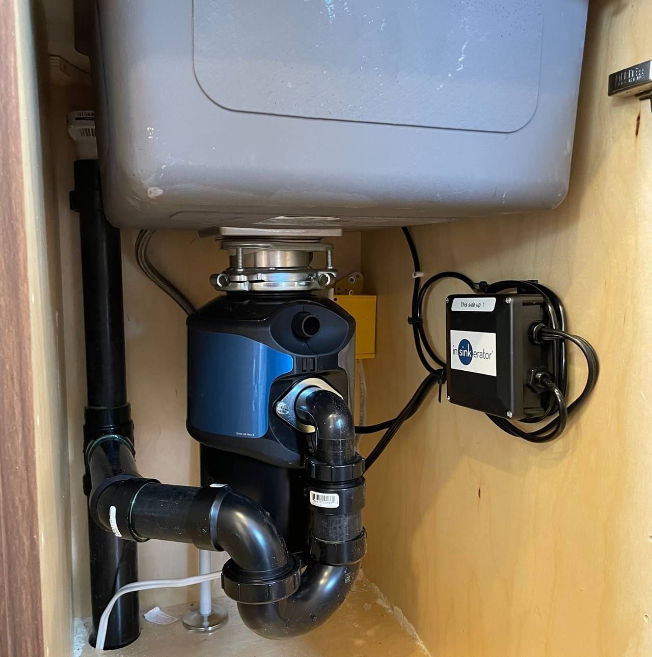 A sink with a garbage disposal attached to it