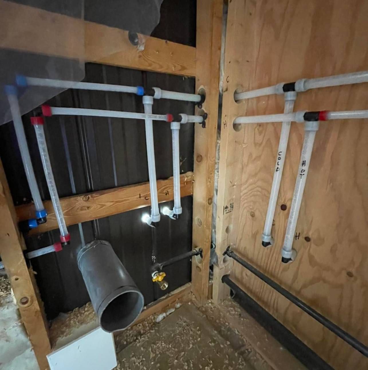 A room with a lot of pipes hanging from the ceiling