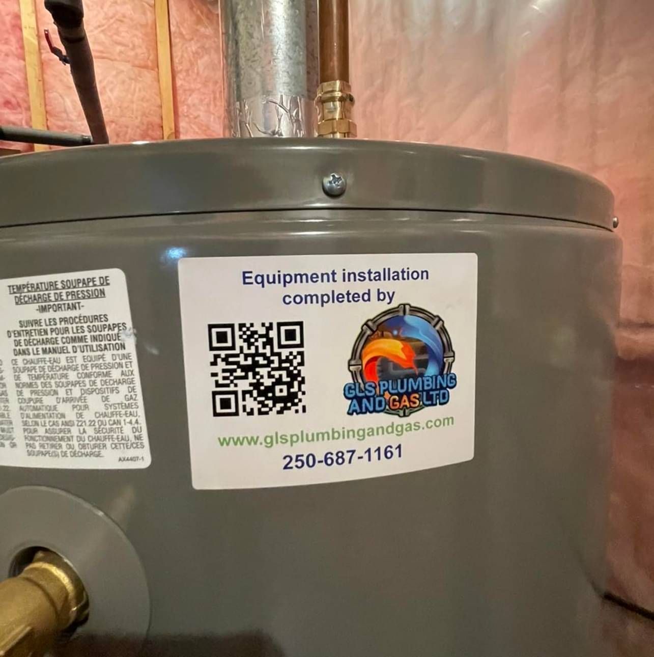 A water heater with a sticker on it that says equipment installation completed by
