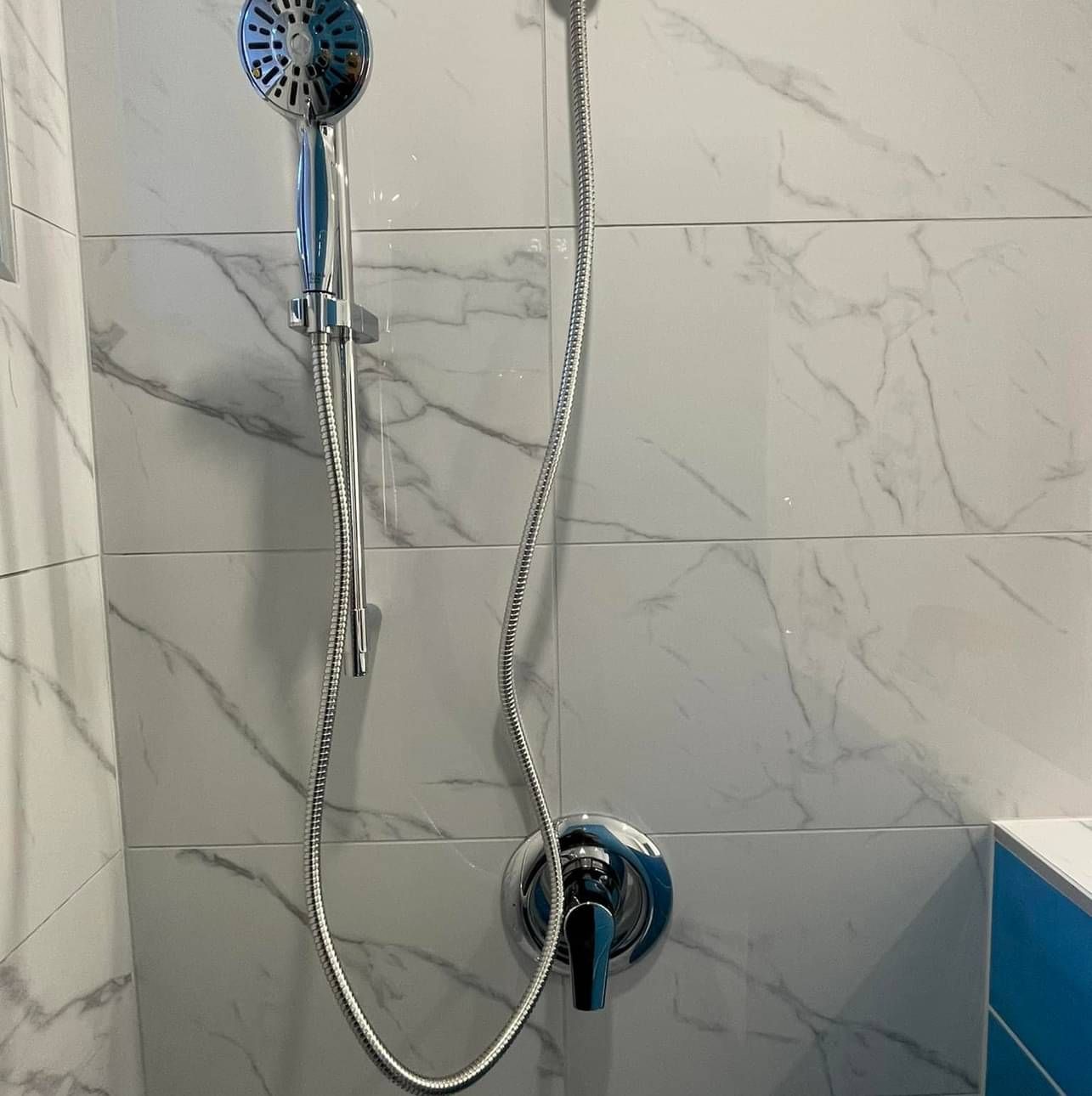 A shower head with a long hose attached to it