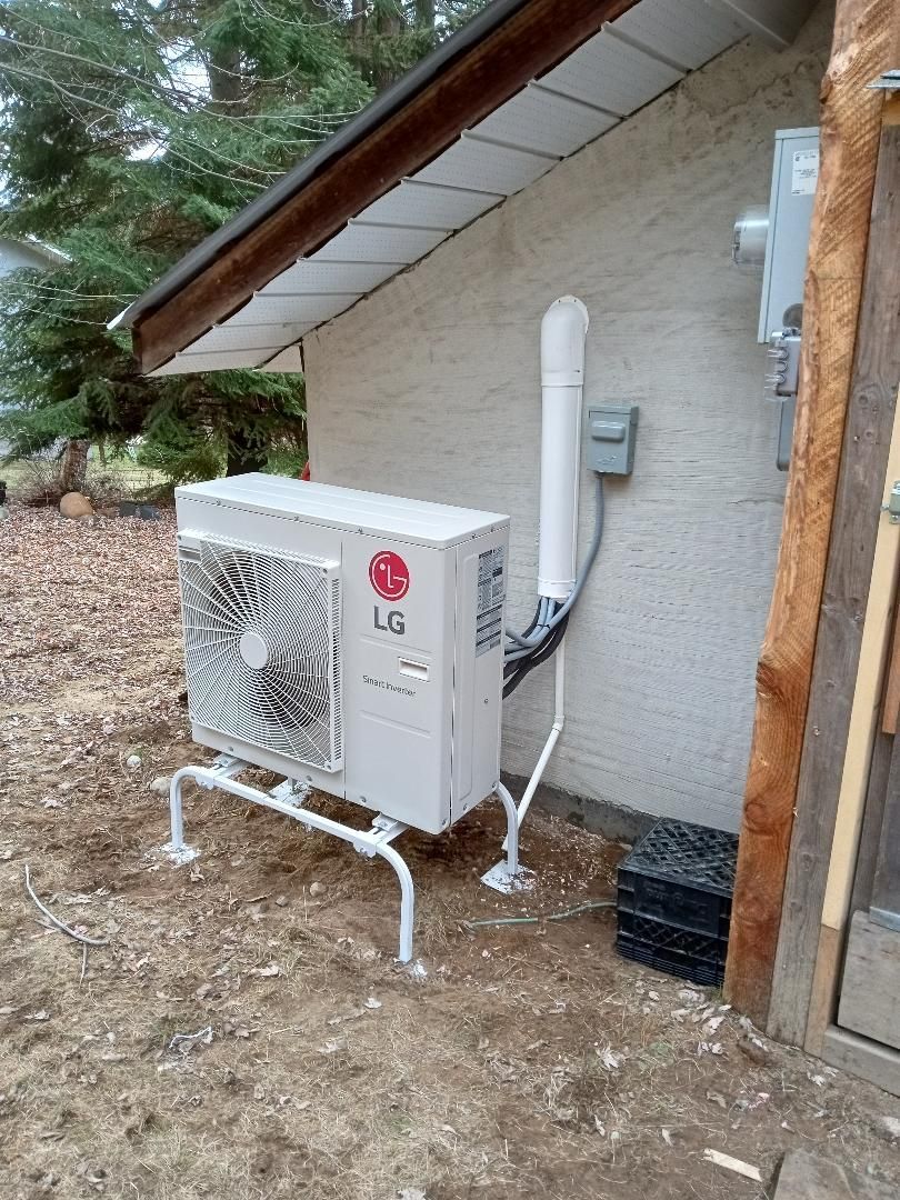 An lg air conditioner is sitting on the side of a building.