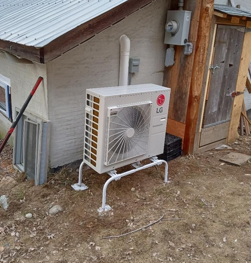 An lg air conditioner is sitting outside of a house