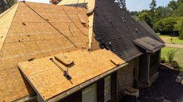 A house with a roof that is being repaired.