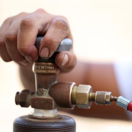 Residential Propane — Hand Holding a Prone Tank in Lipan, TX
