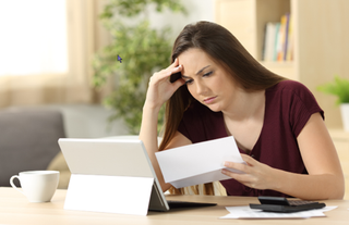 Frustrated woman looking at paper