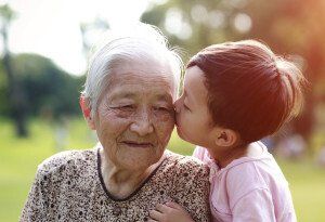 young boy kissing his grandma