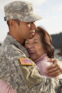 man in uniform hugs older woman