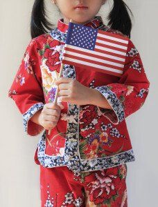 small girl holds american flag