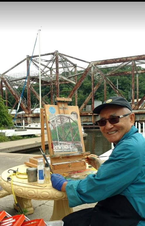 man-painting-a-picture-of-the-bridge