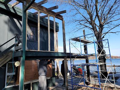 A house is being built on the shore of a lake.