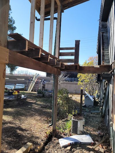 A wooden deck is being built on the side of a house.