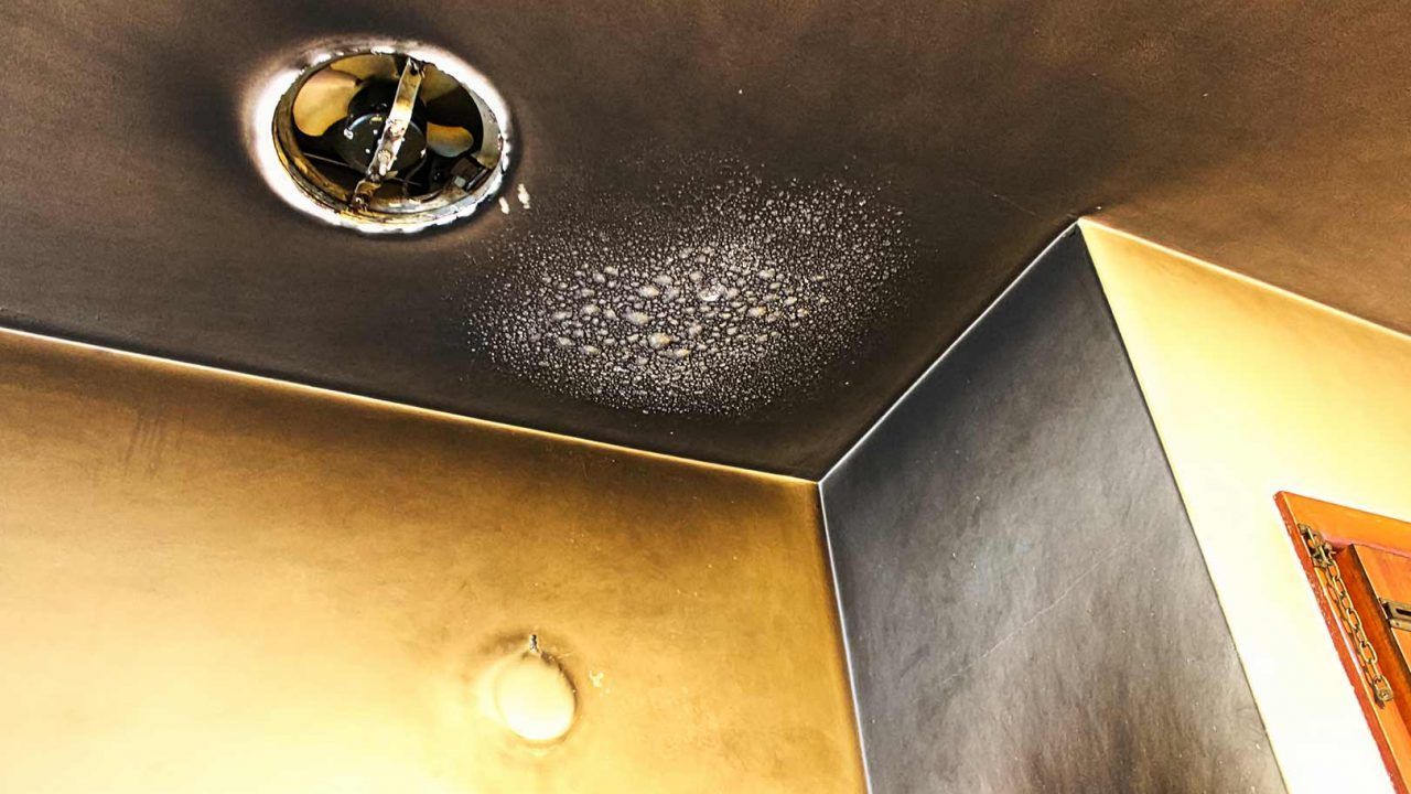 A room with a ceiling that has been damaged by a fire.