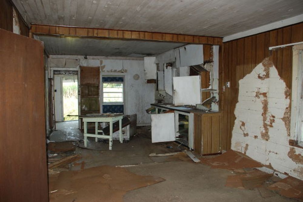 An empty room with a table and chairs in it