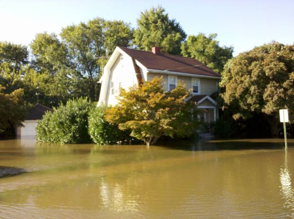 A house is in the middle of a flooded area