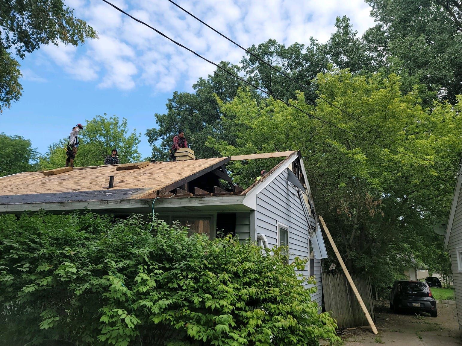 A man is working on the roof of a house.