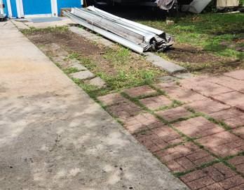 An empty room with a broom and bucket in it.