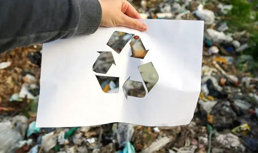 Recycling symbol on a white paper
