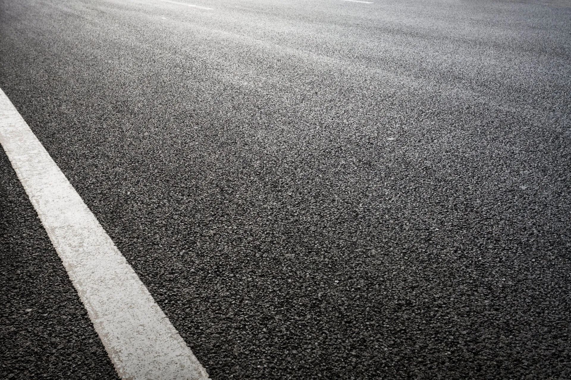 Asphalt road with a single white line marking