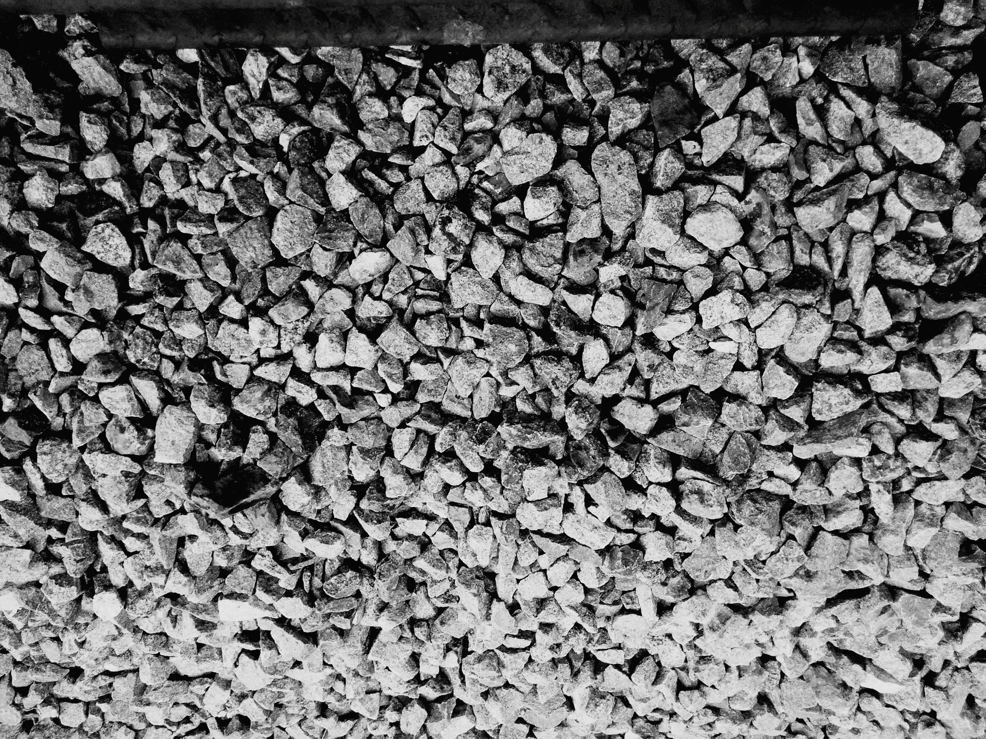 a black and white photo of a pile of gravel .