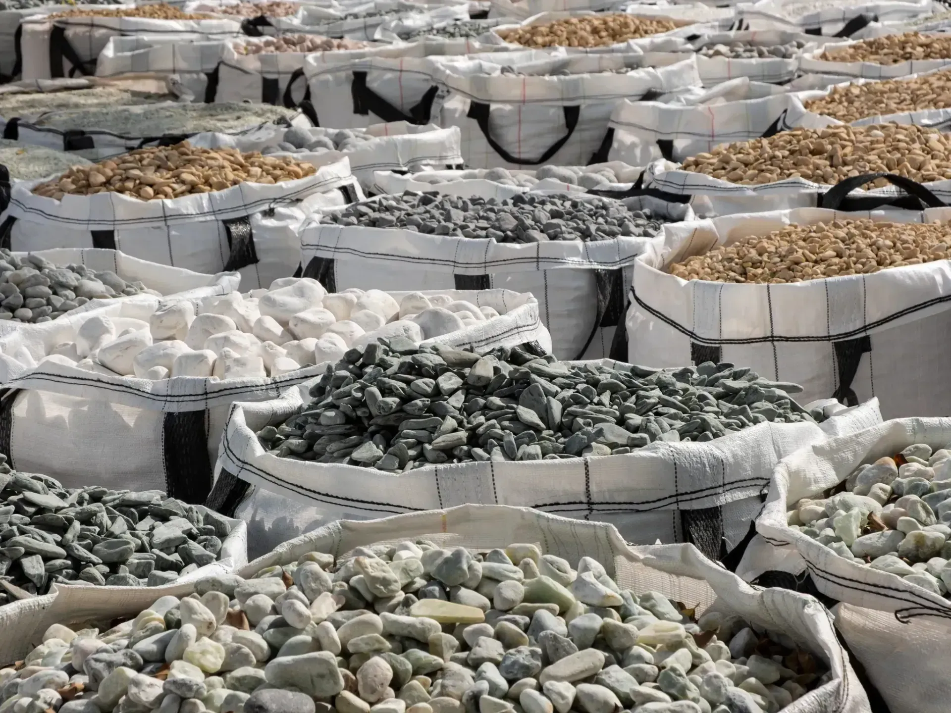 A variety of stones in large fabric bags