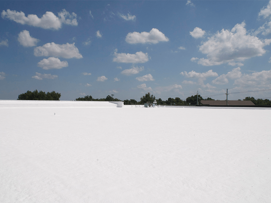 A white roof with a blue sky and clouds in the background