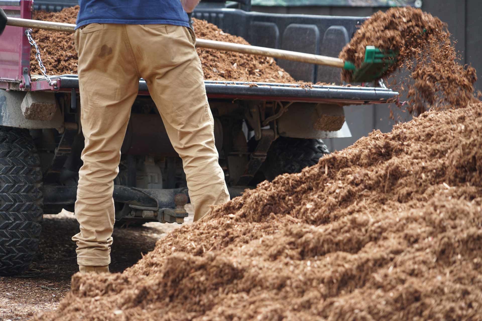 Person shoveling mulch