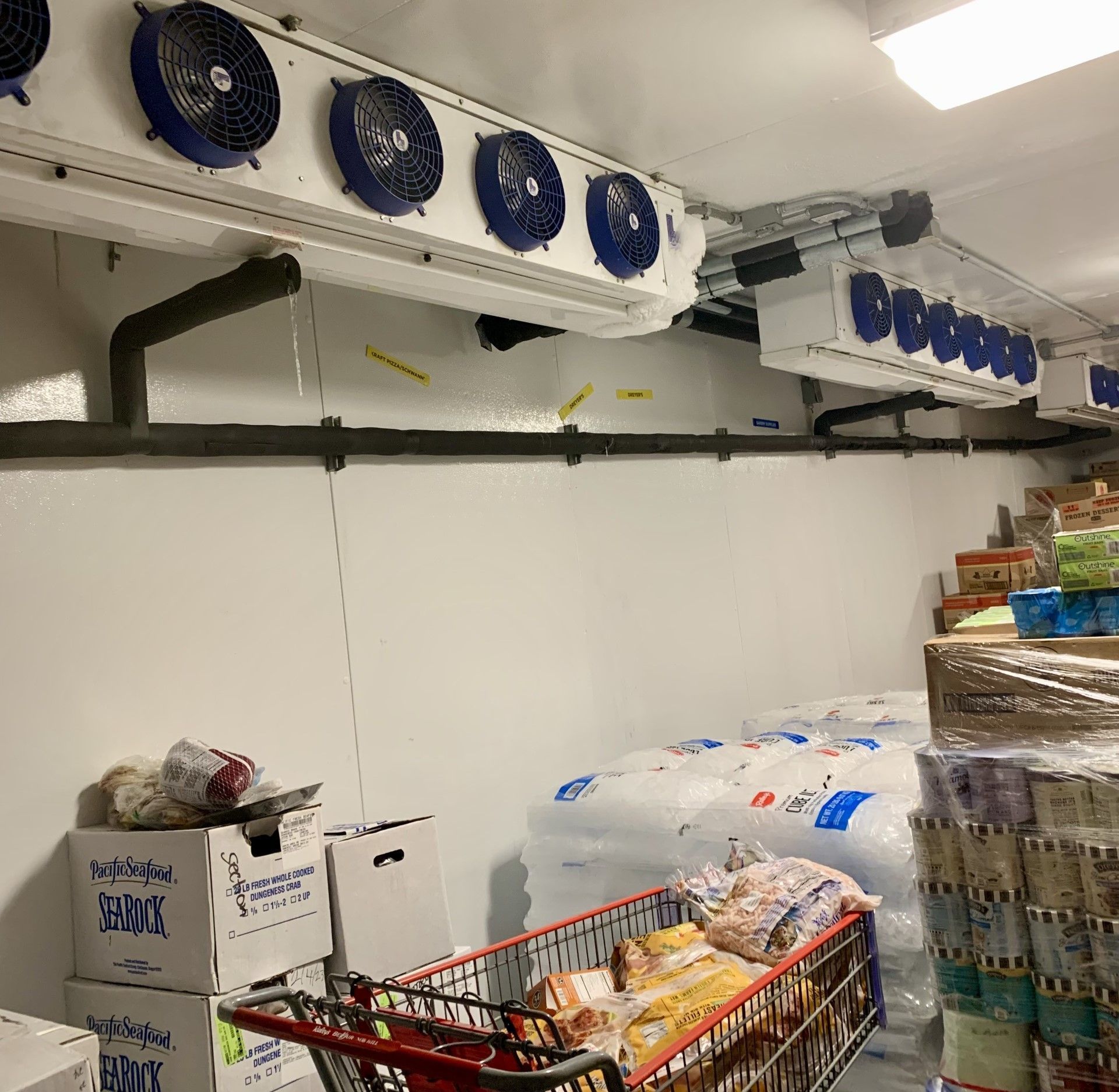 A grocery store with a shopping cart full of food