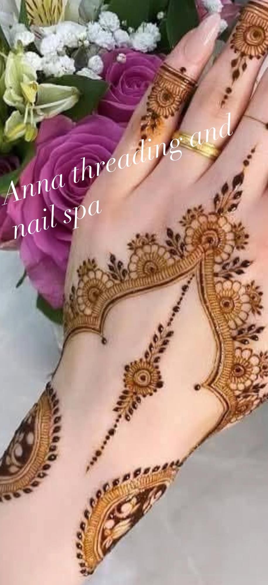 Hand decorated with henna, a floral pattern.