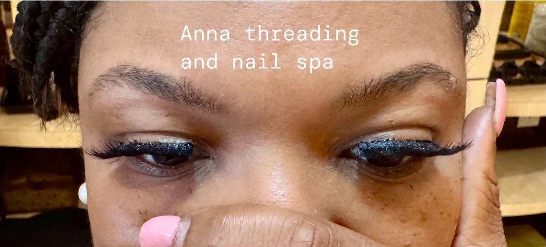 Close-up of eyes with long lashes. A hand holds up a pink-nailed finger. Text 