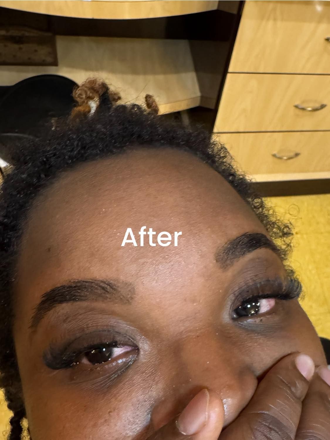 Close-up of a person with dark skin; crying with one eye visible, labeled 