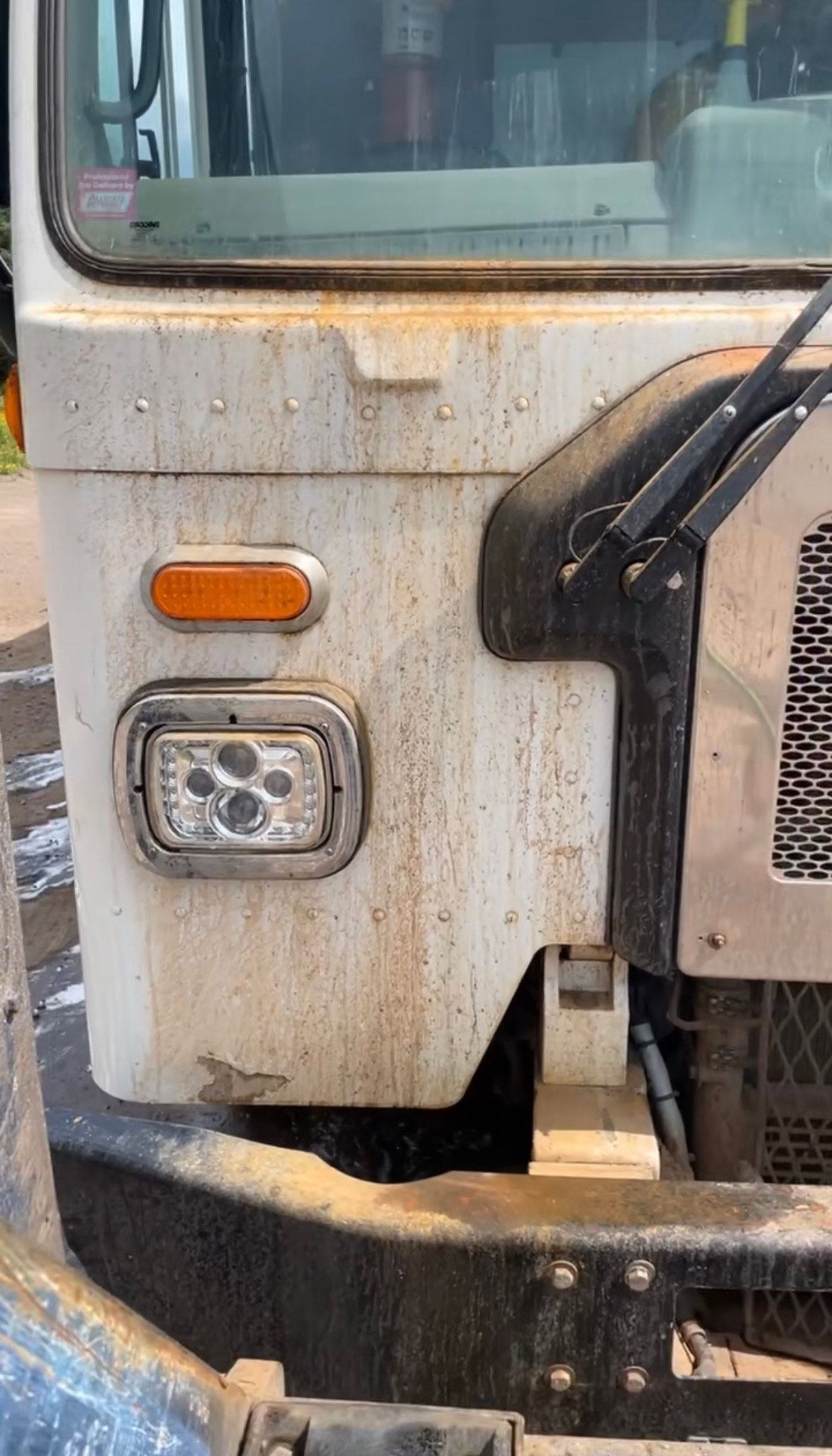 A close up of the front of a dirty truck