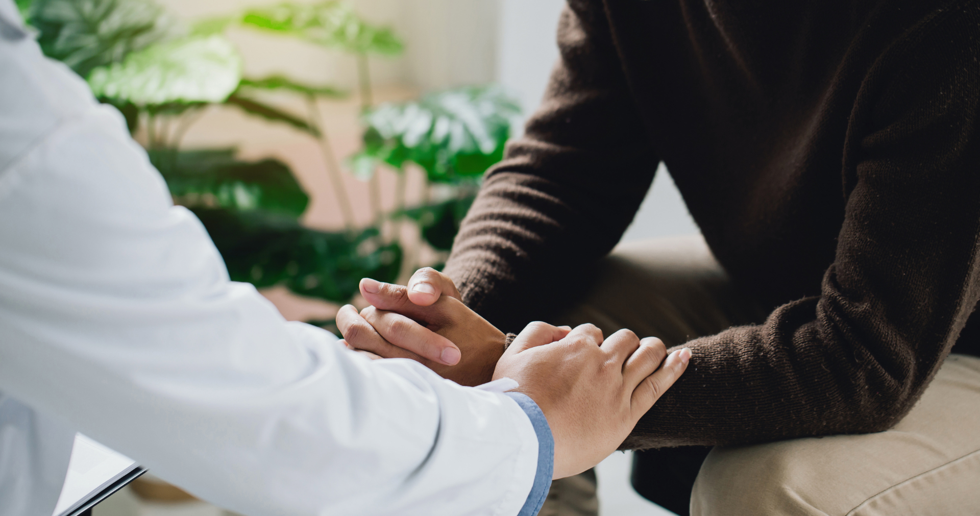 A woman is sitting on a couch talking to another woman.