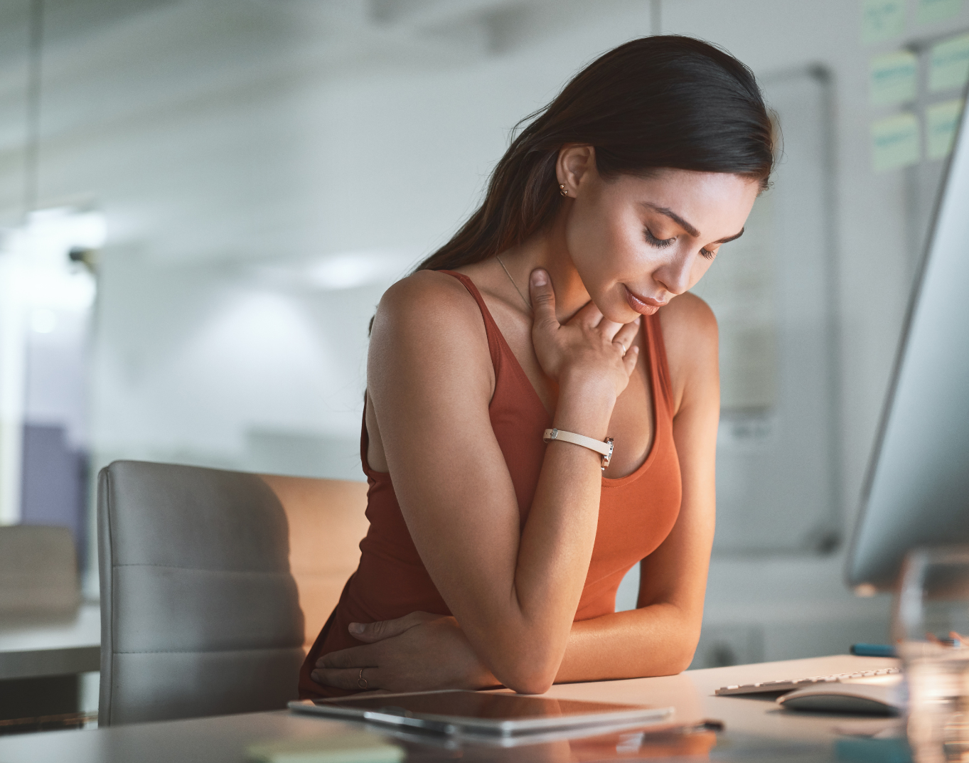 A woman is sitting on a couch talking to a man in a living room.