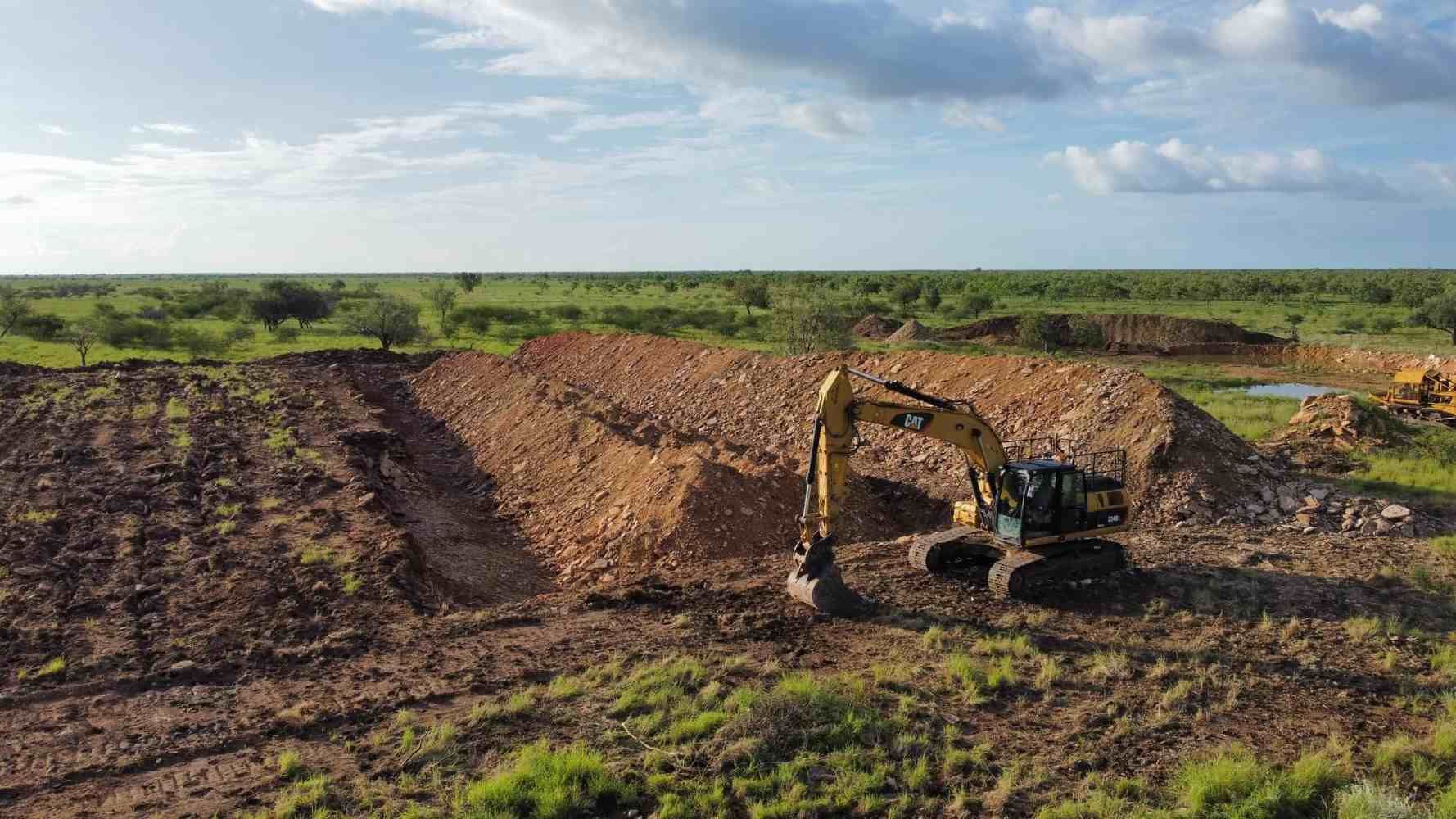 An Aerial View of a Bulldozer Moving Dirt in a Field — Burnett Contracting in Cloncurry, QLD